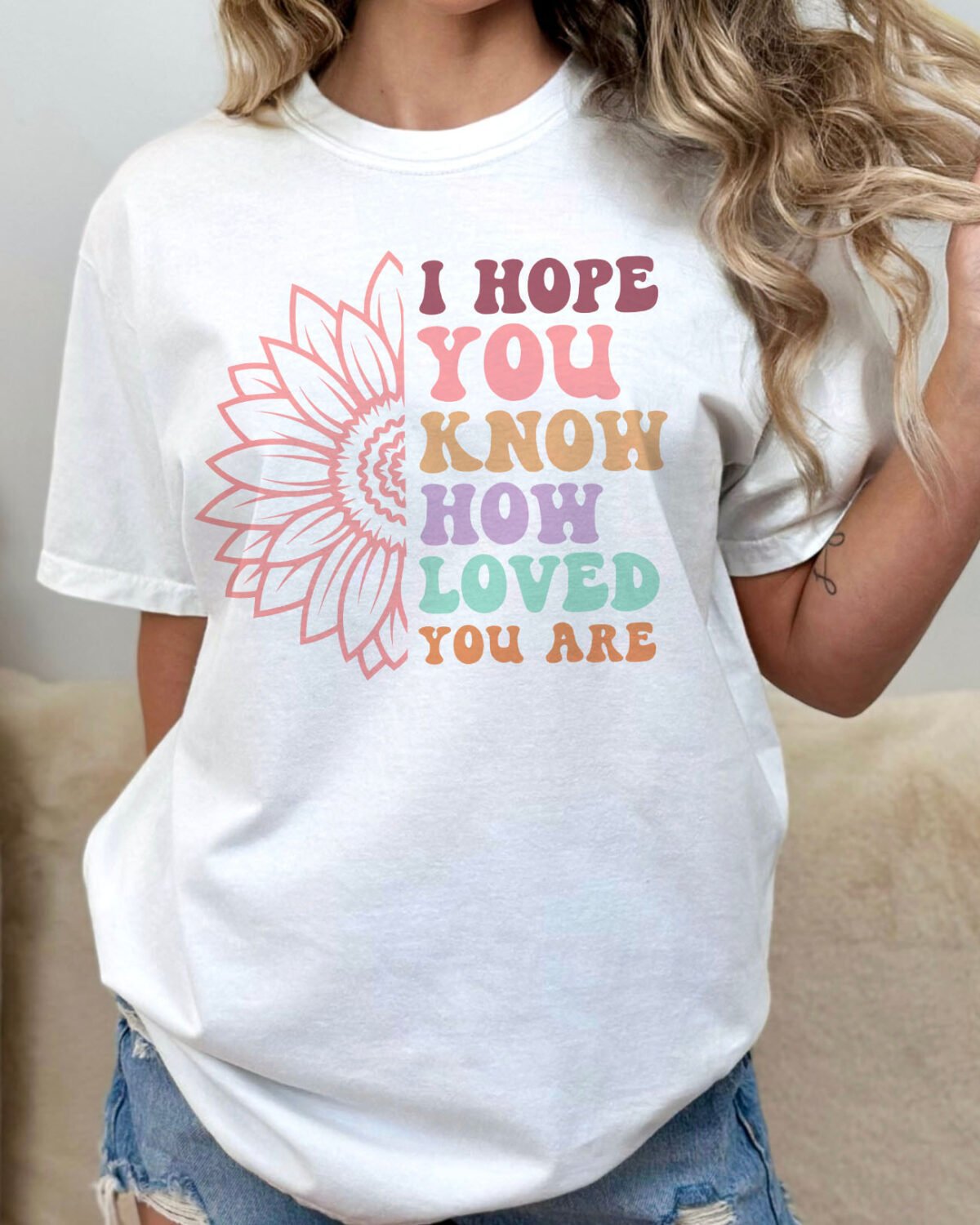 Woman wearing an 'I hope you know how loved you are shirt' in white color