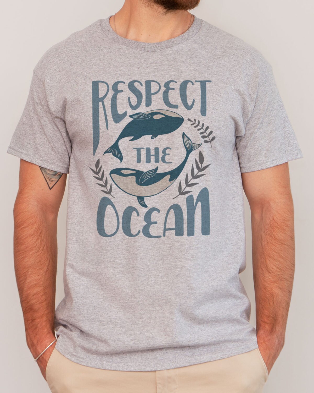 Man wearing a respect the ocean shirt in sport grey color