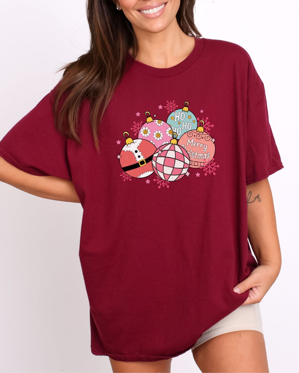 Woman wearing a christmas balls shirt in maroon color